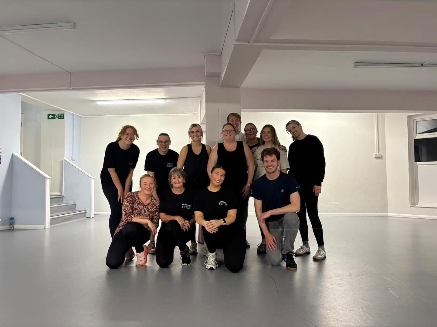 A group of adult dancers with their teachers in the studio