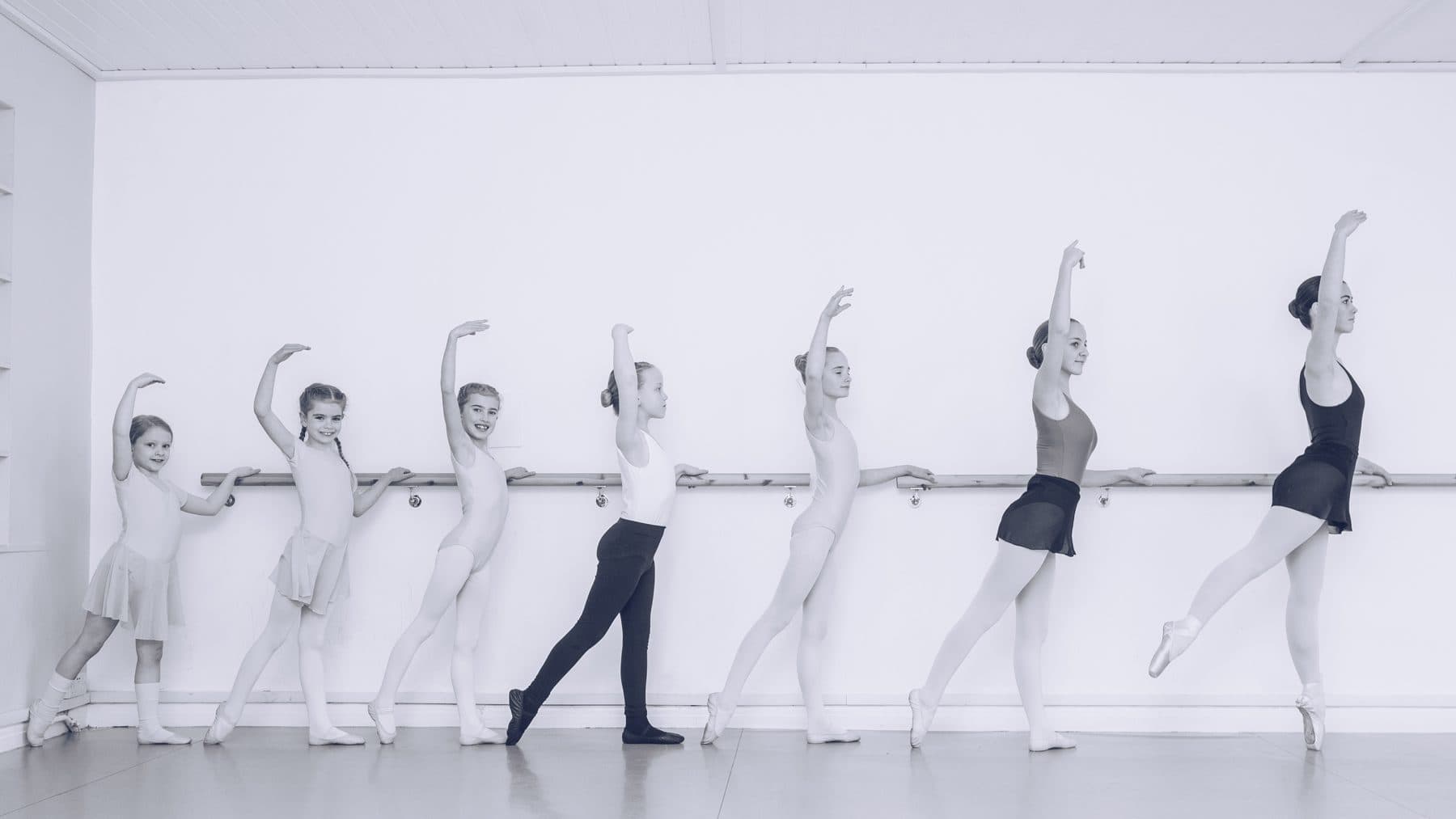 A line of dancers at the barre in the Jazzy J's studio