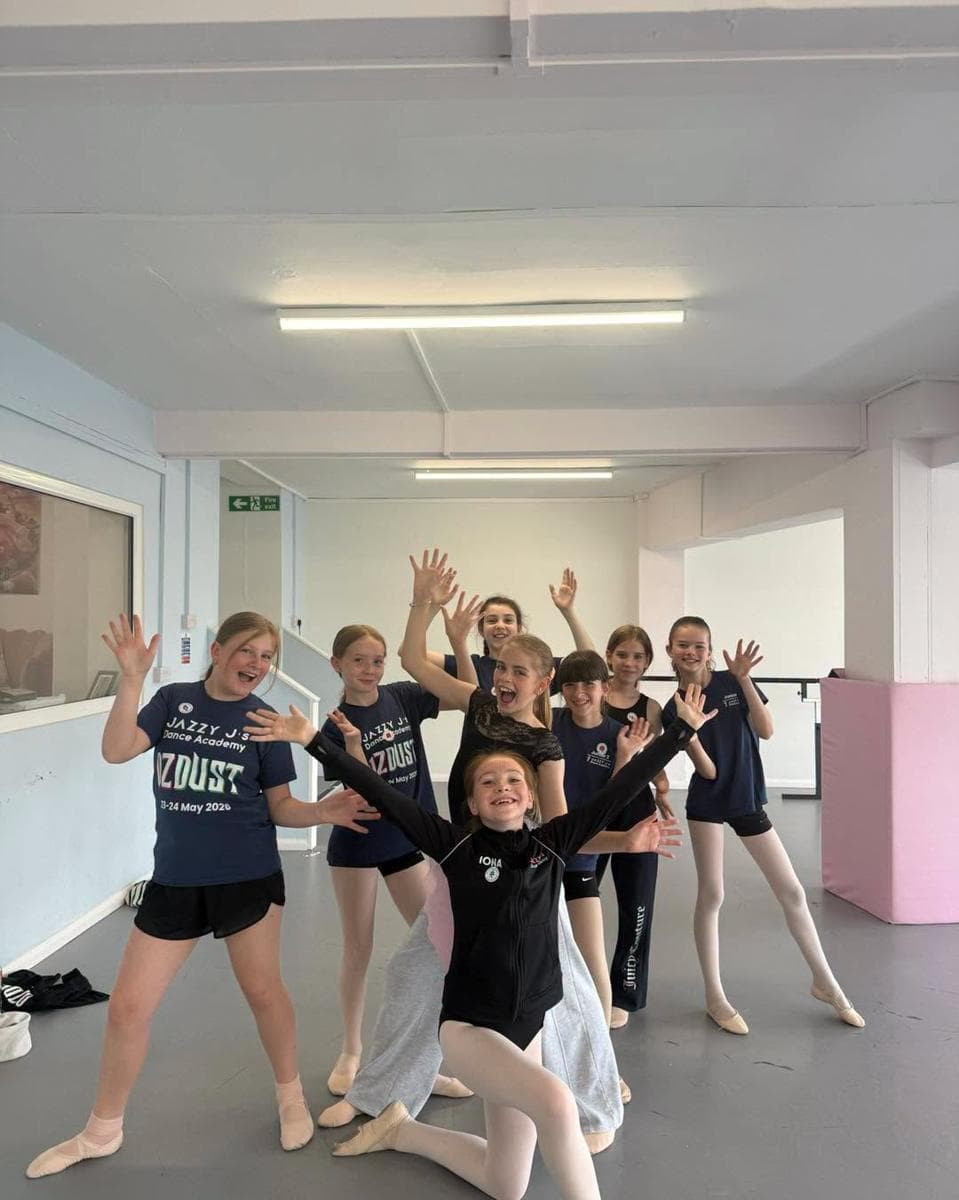 Young dancers waving in the bright new studio