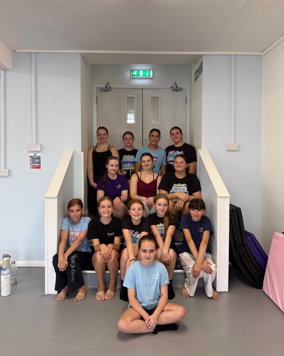 A big group of pupils sitting on the studio staircase