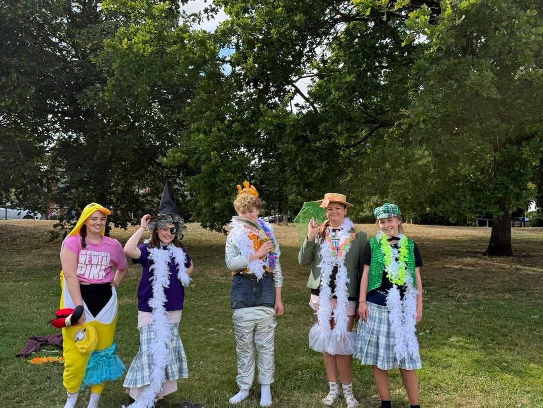 Children in fancy dress on the grass in the park