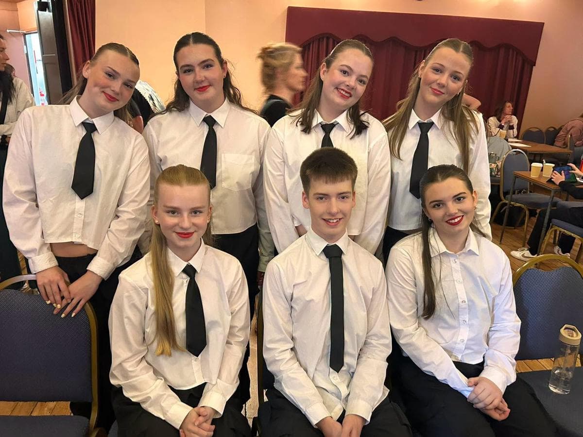 Competition team members in white shirts and black ties