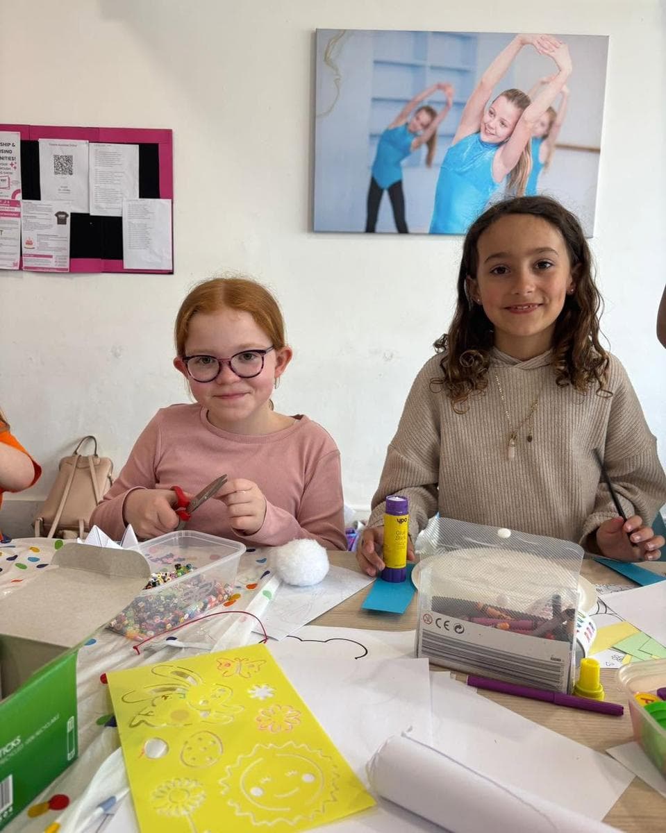 Two girls smiling at the craft table