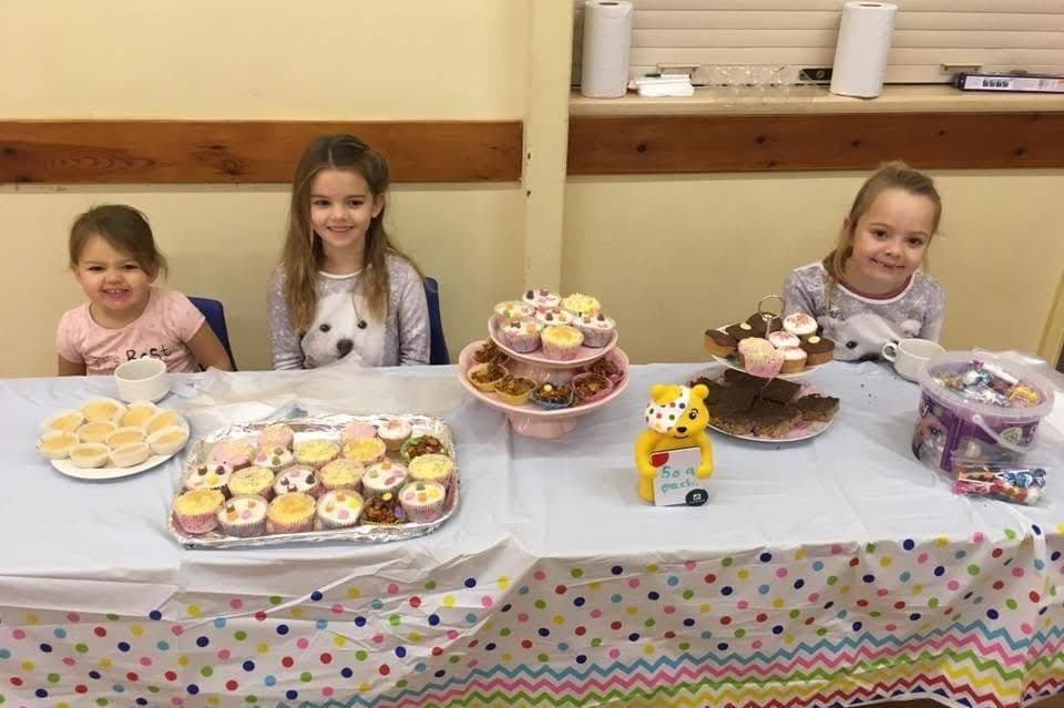 Children at a cake sale table