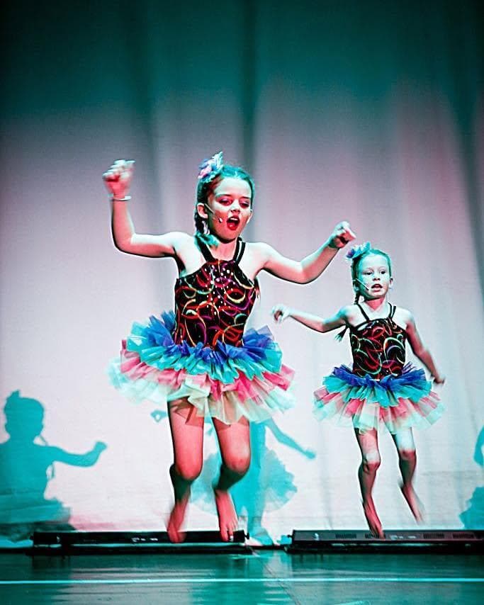 Two young dancers in tutus on stage