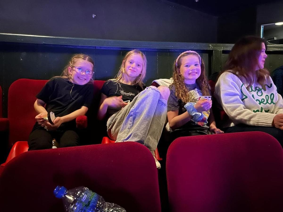 Pupils in theatre seats on a trip
