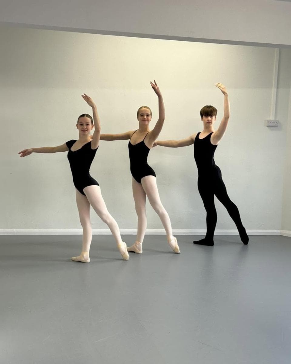 Three ballet dancers in arabesque