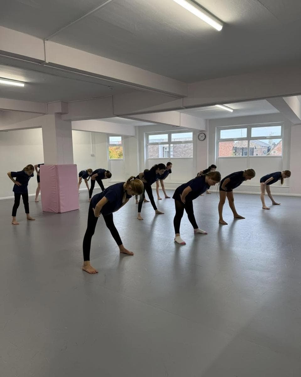 A class stretching in the bright studio
