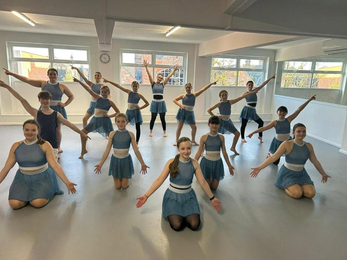 The CYD Team rehearsing in blue costumes