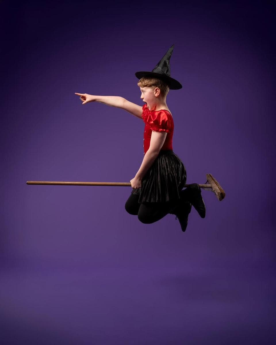 A young witch flying on a broomstick