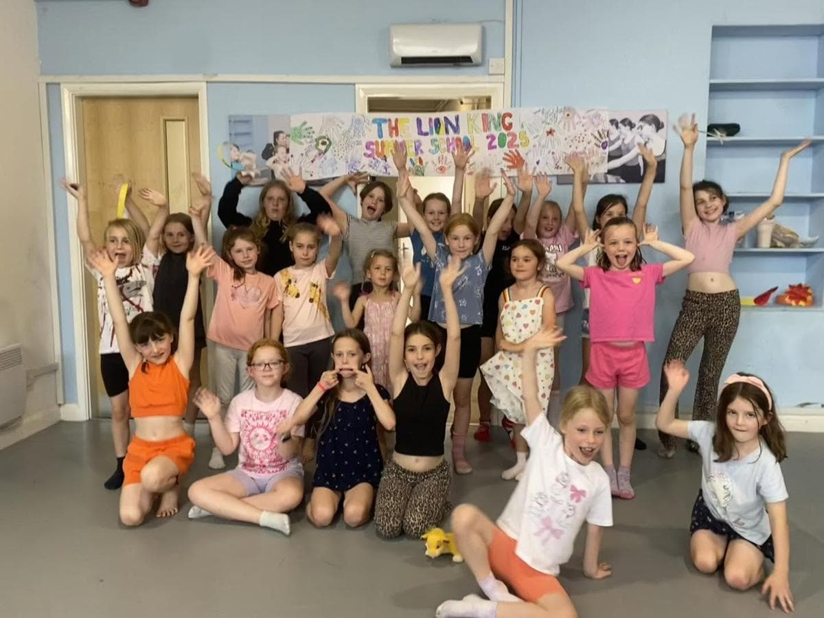 A summer school group with their painted banner